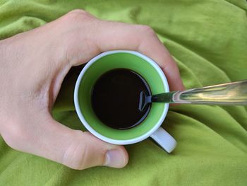 Close-up of hand holding coffee cup
