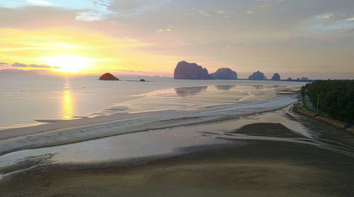 Scenic view of beach against sky during sunset