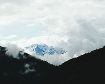 Scenic view of snow covered mountains against sky