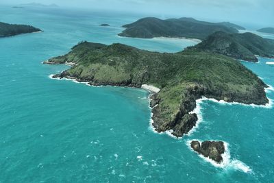 High angle view of rocks on sea against sky