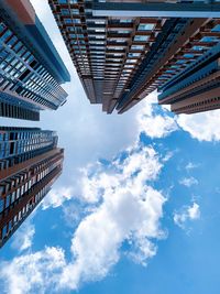 Low angle view of buildings against cloudy sky