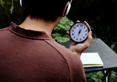 Rear view of a woman holding umbrella