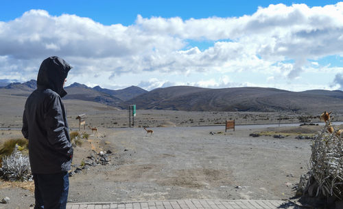 Man standing on landscape against sky