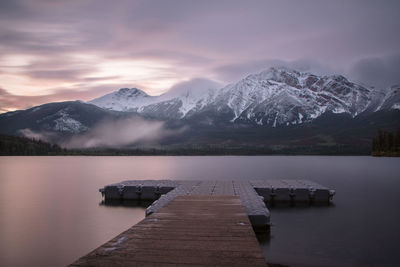 Scenic view of lake and mountains against sky during winter