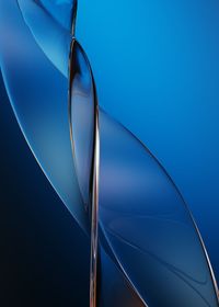 Low angle view of metallic pole against blue sky