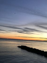 Scenic view of sea against sky at sunset