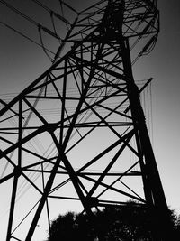 Low angle view of electricity pylon against sky