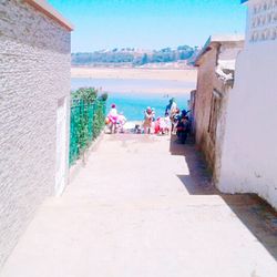 People at beach against sky