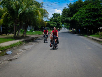 People riding bicycle on road