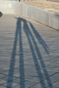 Shadow of people on footpath