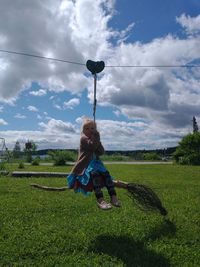 Full length of boy on field against sky