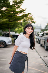 Young woman standing on road