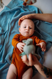 Close-up of baby boy sleeping on bed