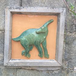 Close-up of animal statue against wall