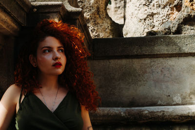 Portrait of beautiful young woman looking away