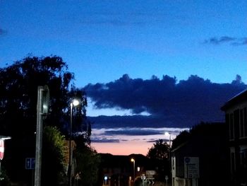 Illuminated houses against sky at night