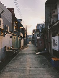 Houses against sky at sunset