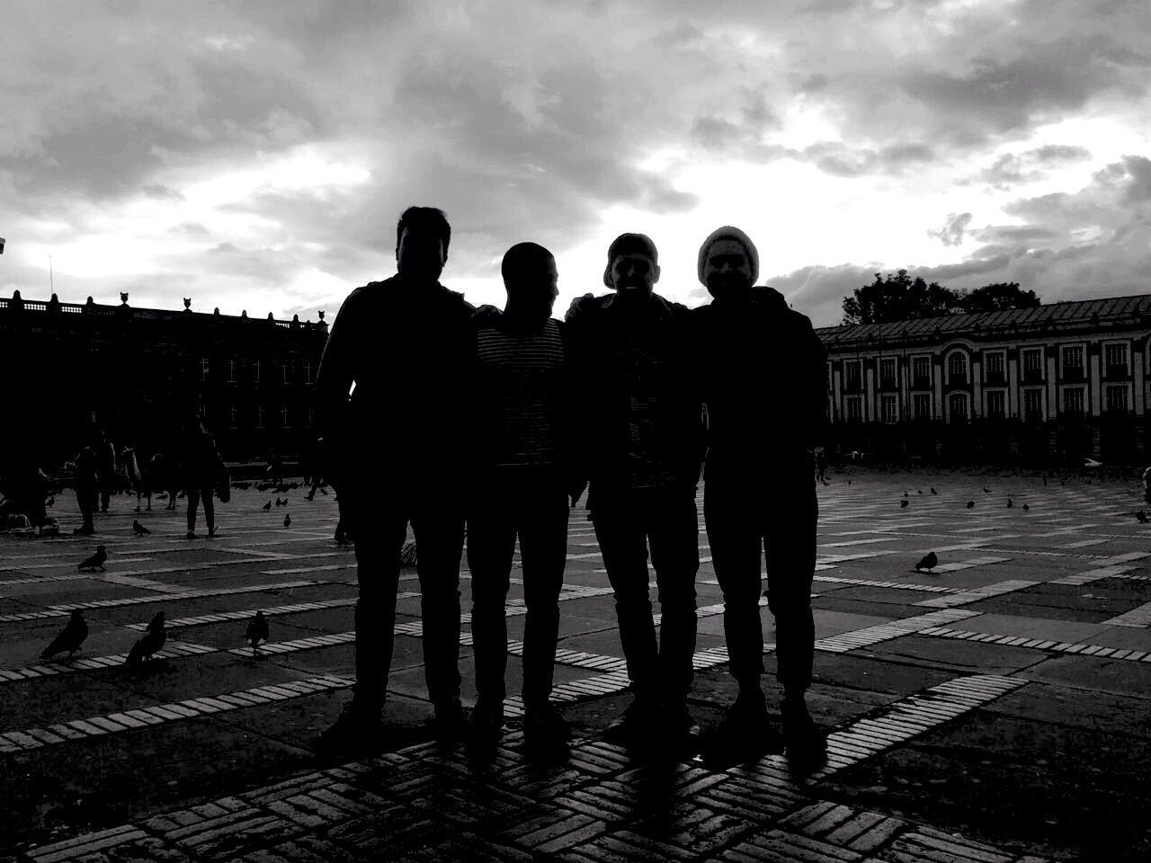 sky, men, cloud - sky, lifestyles, walking, architecture, person, building exterior, built structure, leisure activity, full length, togetherness, cloudy, standing, cloud, street, rear view, large group of people, city