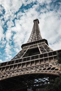 Low angle view of eiffel tower against cloudy sky