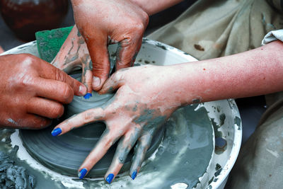 Close-up of hands working in water