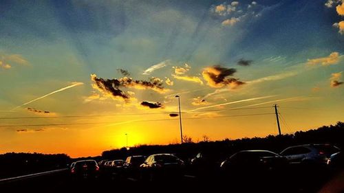 Cars on road at sunset