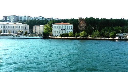 Calm river with buildings in background