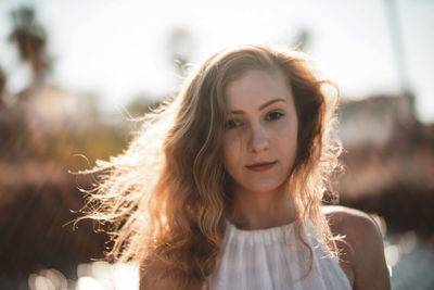 Close-up portrait of young woman during sunny day