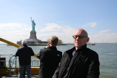 Men standing at seaside