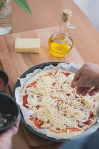 Close-up of person making pizza