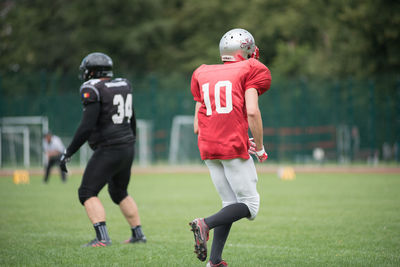 Full length of boy running on grass