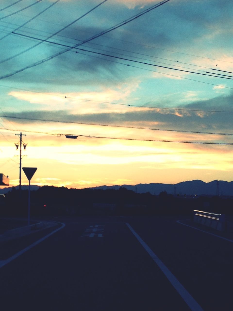 sunset, sky, power line, silhouette, electricity pylon, cloud - sky, orange color, road, transportation, scenics, electricity, cloud, cable, beauty in nature, tranquil scene, tranquility, nature, connection, power supply, landscape