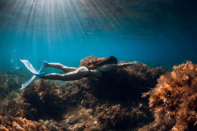 Young woman swimming in sea