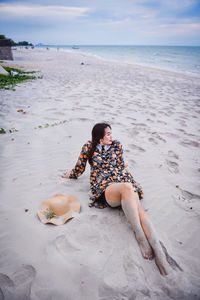 Young woman sitting on beach