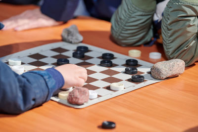 Midsection of man playing chess