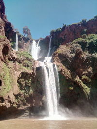 Scenic view of waterfall against clear sky