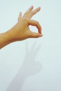 Close-up of woman hand over white background