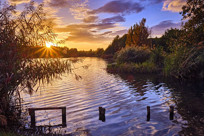 Scenic view of lake against sky during sunset
