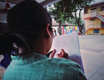 Close-up of woman reading book