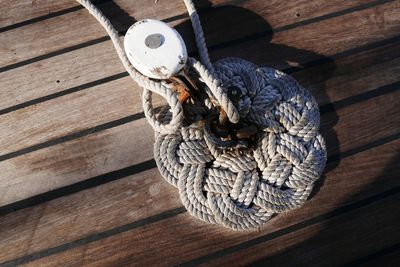 Directly above shot of rope tied to cleat on pier