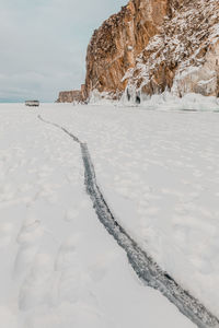 Scenic view of snow covered land against sky
