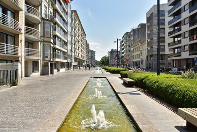 Street amidst buildings against sky