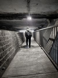 Man standing in illuminated tunnel