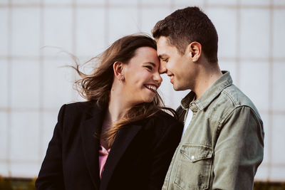 Side view of young couple standing outdoors