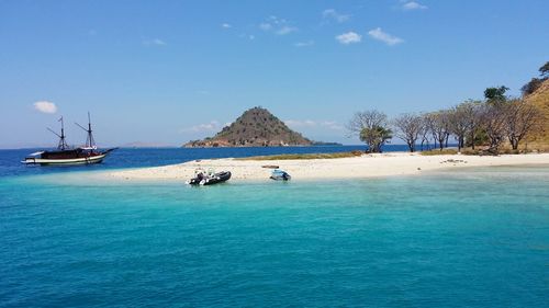Sailboats in sea against sky