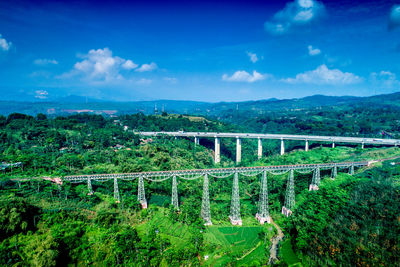 Bridge over landscape against blue sky