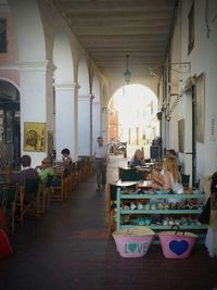 Close-up of people sitting on wall