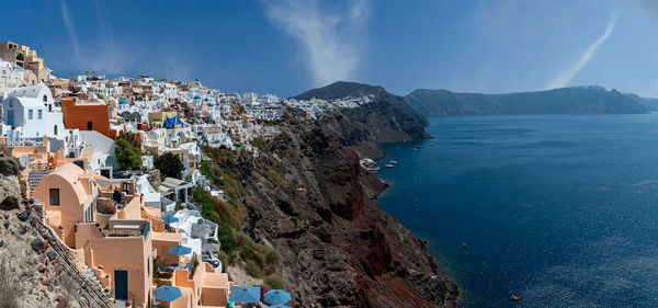 Panoramic view of townscape by sea against sky