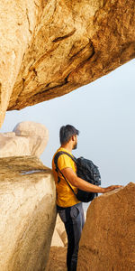 Side view of man standing on rock