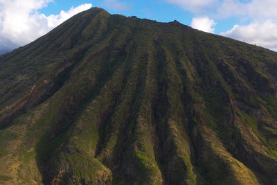 Low angle view of volcanic mountain against sky