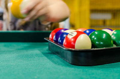 Close-up of snooker balls with person in background